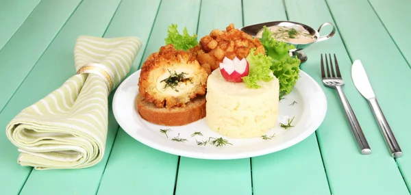 Chicken Kiev on croutons with mashed potatoes, on wooden background — Stock Photo, Image