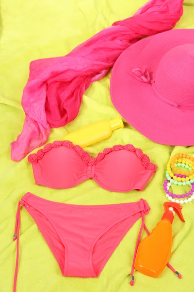 Swimsuit and beach items on bright background — Stock Photo, Image