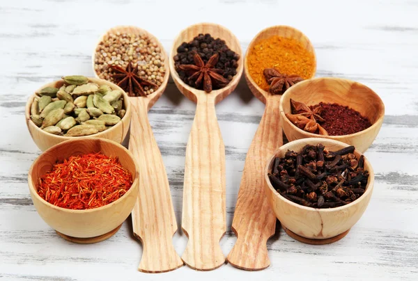 Various spices and herbs on wooden background — Stock Photo, Image