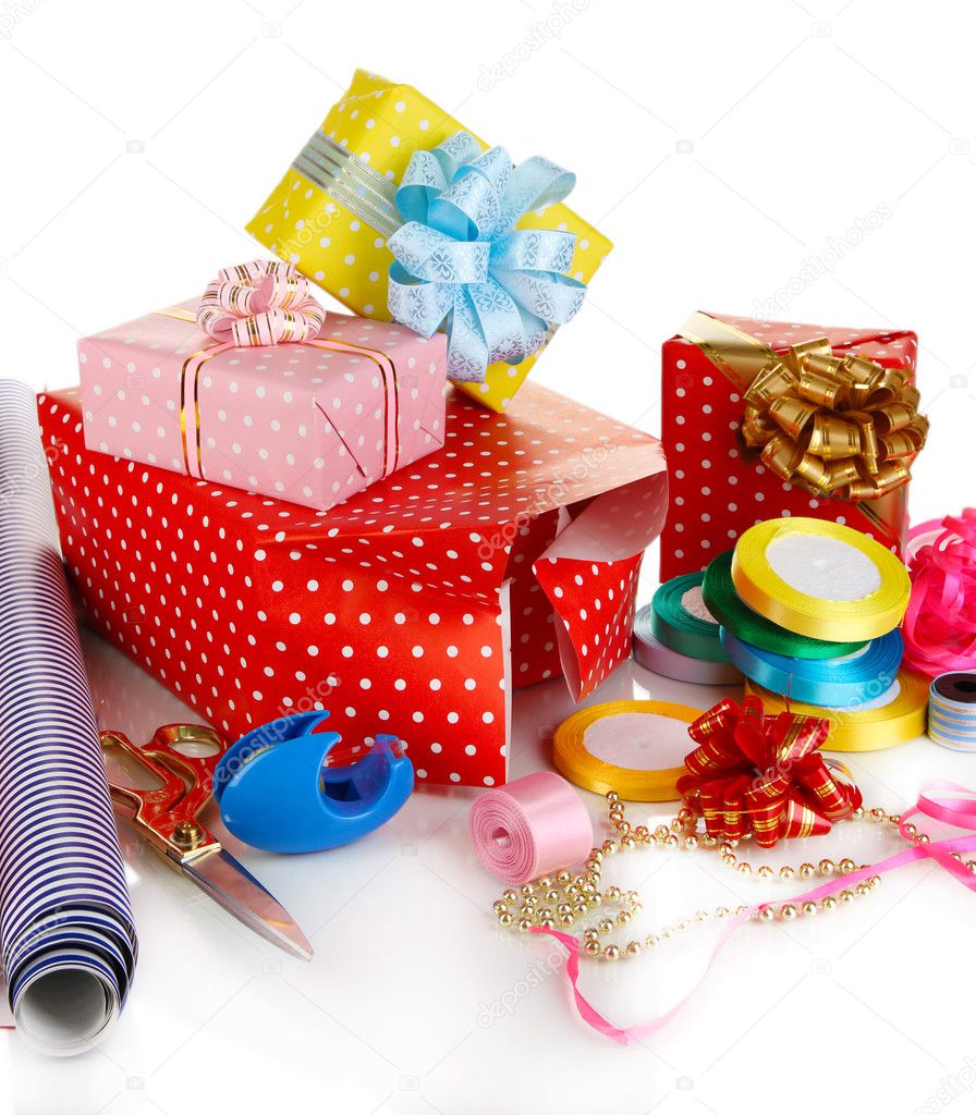 Materials and accessories for wrapping gifts with holiday gifts isolated on white