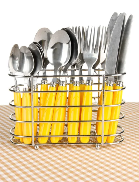Messer, Gabeln und Löffel aus Metall stehen auf Tischdecke auf weißem Hintergrund — Stockfoto