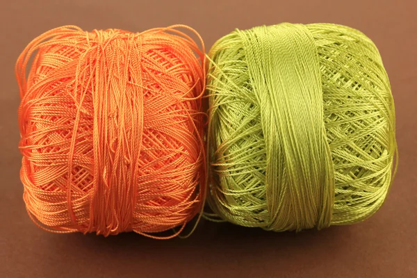 Colored skeins on brown background — Stock Photo, Image