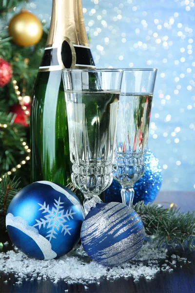 Composition with Christmas decorations and two champagne glasses, on bright background — Stock Photo, Image