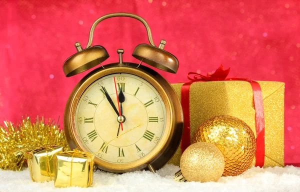 Composition of clock and christmas decorations on bright background — Stock Photo, Image