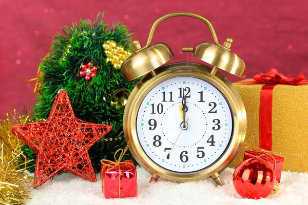 Composition of clock and christmas decorations on bright background — Stock Photo, Image