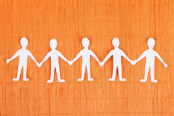 Paper people in social network concept on orange bamboo background — Stock Photo, Image