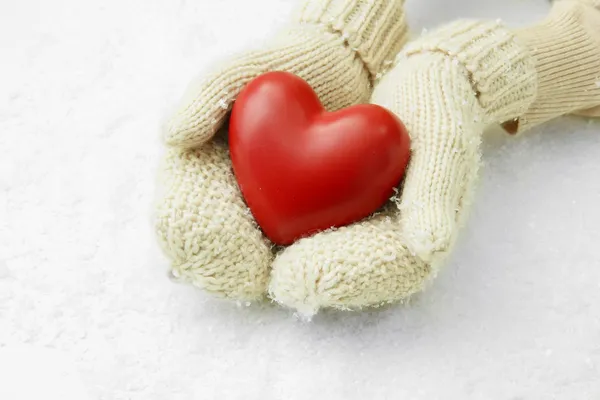 Female hands in mittens with red heart, close-up — Stock Photo, Image