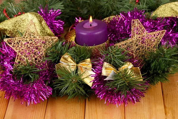 Christmas composition with candles and decorations in purple and gold colors on wooden background — Stock Photo, Image