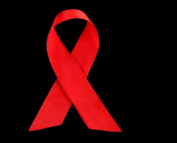 HIV, AIDS üzerine siyah izole kırmızı kurdele — Stok fotoğraf