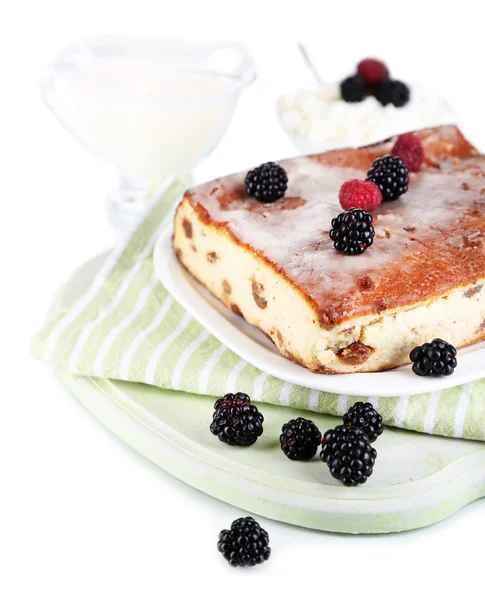 Cheese casserole with raisins on plate on napkin isolated on white — Stock Photo, Image