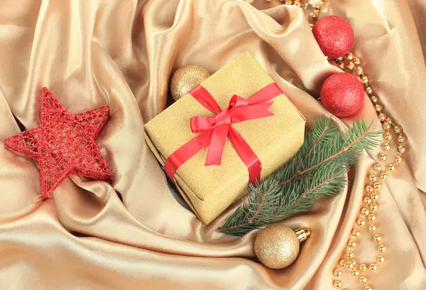 Beautiful bright gift and christmas decor, on silk cloth — Stock Photo, Image