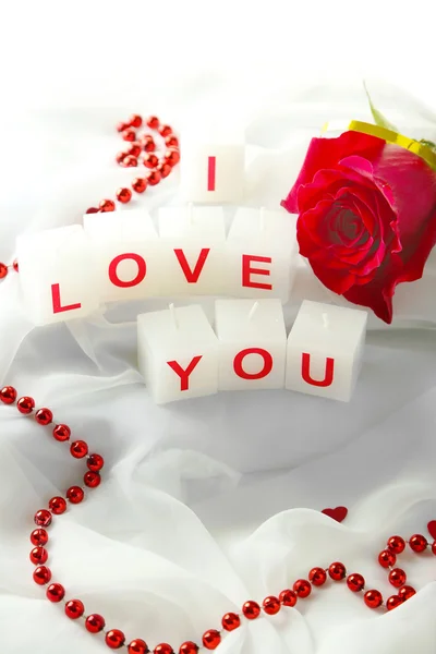 Candles with printed sign I LOVE YOU,on white fabric background — Stock Photo, Image