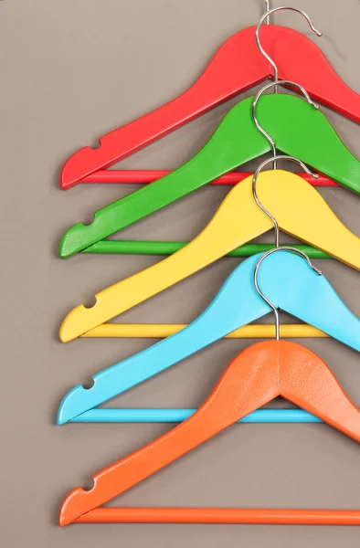 Colorful clothes hangers on gray background — Stock Photo, Image