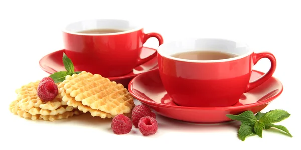 Cups of tea with cookies and raspberries isolated on white — Stock Photo, Image