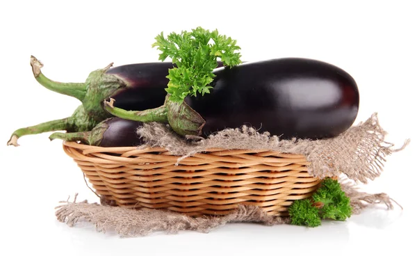 Fresh eggplants in wicker basket isolated on white — Stock Photo, Image