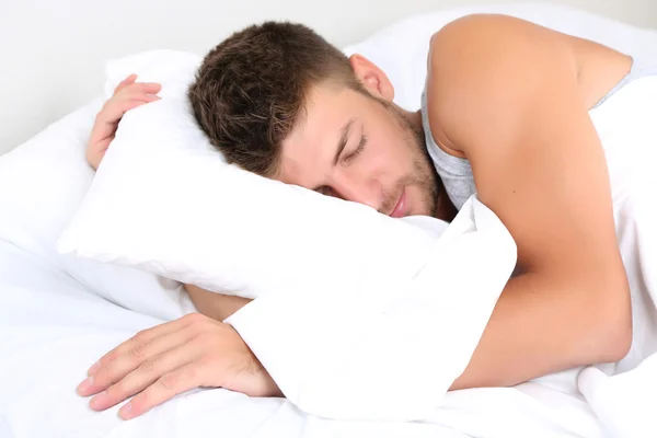 Handsome young man in bed — Stock Photo, Image