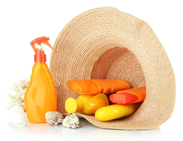 Bottles with suntan cream in hat isolated on white — Stock Photo, Image