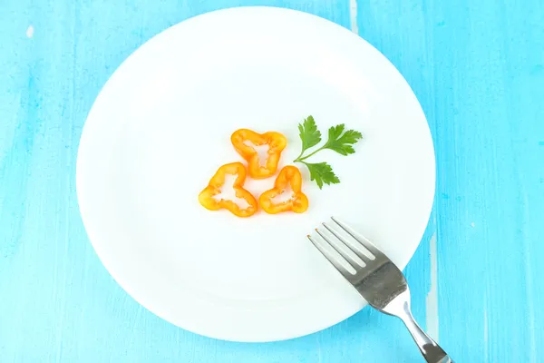 Small portion of food on big plate on wooden table close-up — Stock Photo, Image