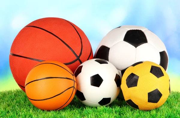 Sport balls, on green grass, on bright background — Stock Photo, Image