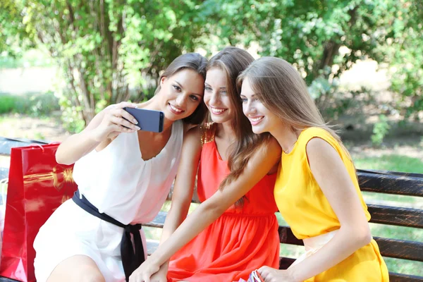 Drie mooie jonge vrouw nemen foto in zomer park — Stockfoto