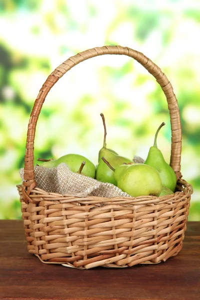 Pears in wicker basket, on bright background — Stock Photo, Image