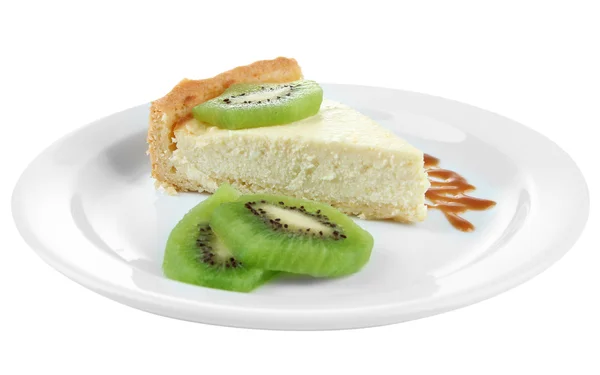 Slice of cheesecake with kiwi fruit and caramel sauce on plate, isolated on white — Stock Photo, Image