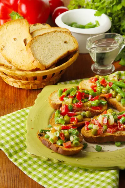 Sandwiches with vegetables and greens on plate on wooden table close-up — Stock Photo, Image