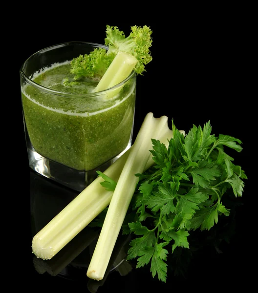 Glass of green vegetable juice and celery isolated on black — Stock Photo, Image