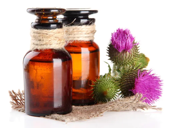 Medicine bottles with thistle flowers, isolated on white — Stock Photo, Image