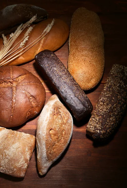 Much bread on wooden board — Stock Photo, Image