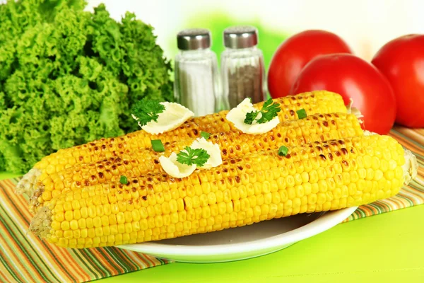 Delicious golden grilled corn with butter on table on bright background — Stock Photo, Image