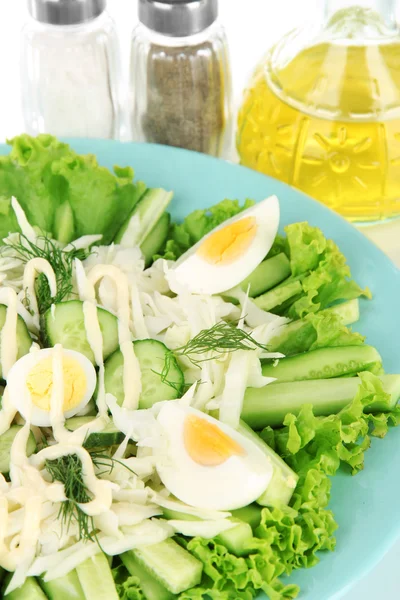 Delicious salad with eggs, cabbage and cucumbers, isolated on white — Stock Photo, Image