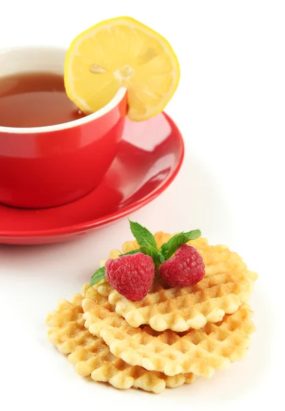 Cup of tea with cookies and raspberries isolated on white — Stock Photo, Image