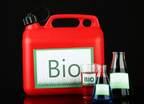 Bio fuels in canister and vials on black background — Stock Photo, Image