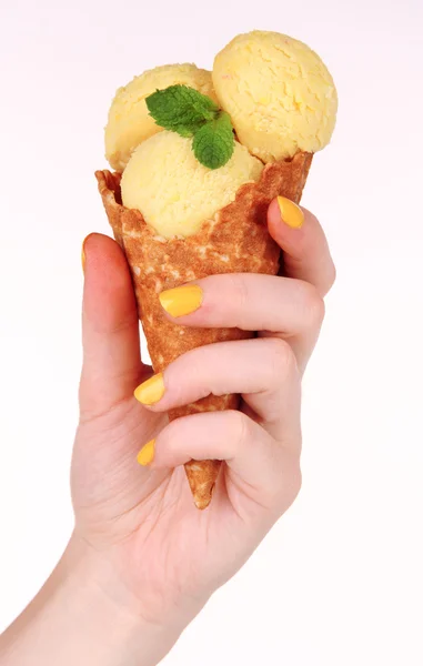 Hand holding yellow ice cream with mint in waffle cone isolated on white — Stock Photo, Image