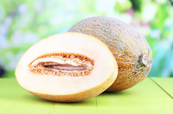 Ripe melons on wooden table on natural background — Stock Photo, Image