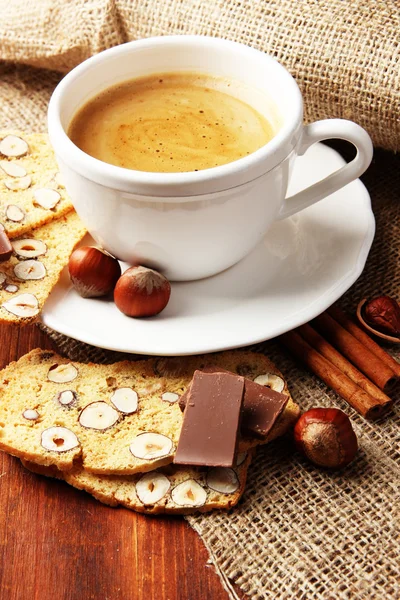 Cup of tasty coffee with Italian biscuit, on wooden background — Stock Photo, Image