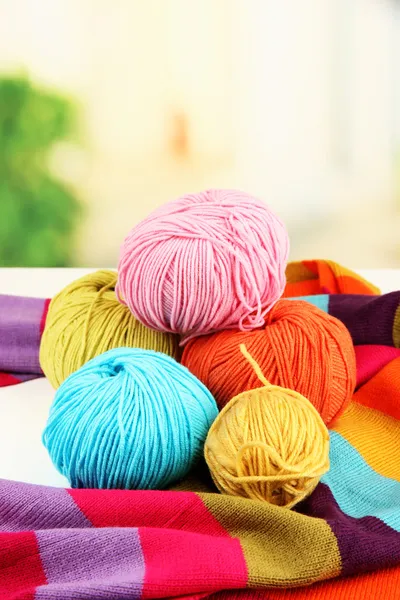 Multicolored clews with bright scarf closeup — Stock Photo, Image