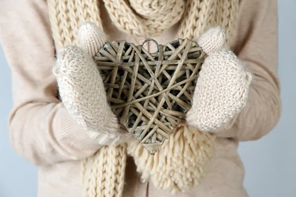 Female hands with wicker heart, close-up — Stock Photo, Image