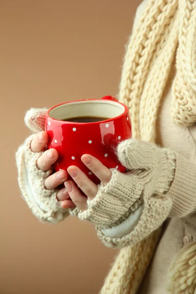 Female hands with hot drink, on color background — Stock Photo, Image