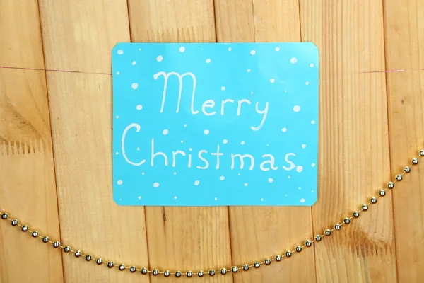 Signboard with words Merry Christmas on wooden table background close-up — Stock Photo, Image