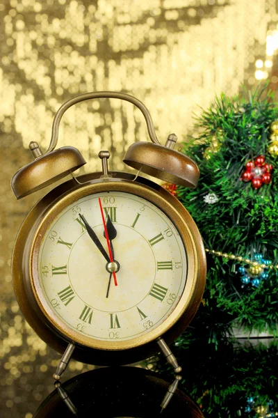 Composition of clock and christmas decorations on bright background — Stock Photo, Image