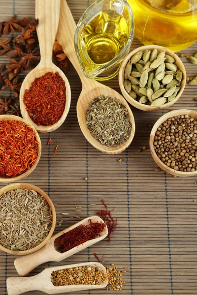 Many different spices and fragrant herbs on wooden table close-up