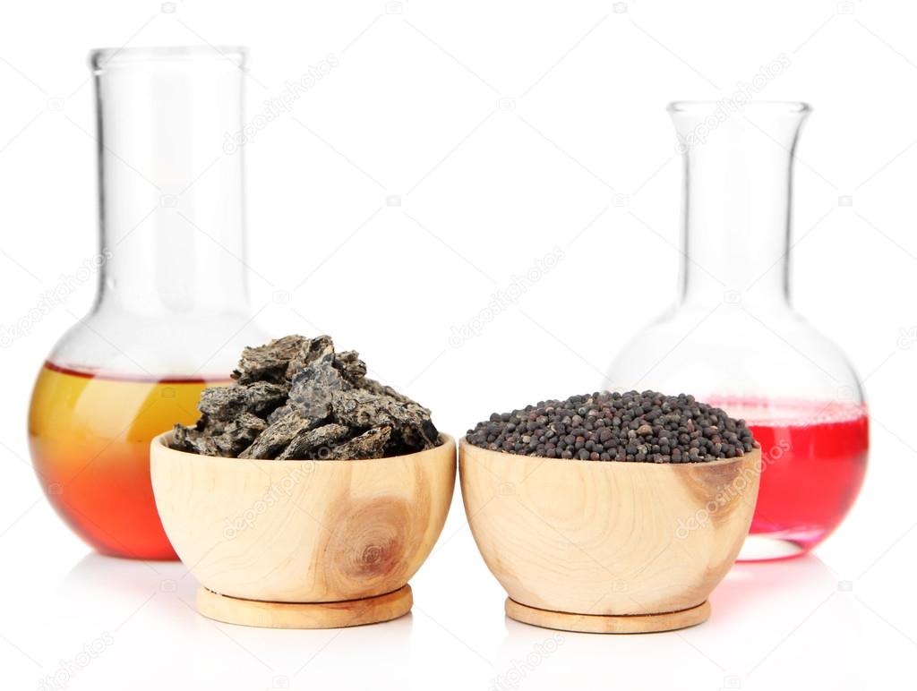 Beakers with bio fuel from rape seeds, oil cakes, isolated on white