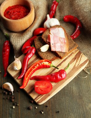 salsa soslu ekmek,, red hot chili biber ve sarımsak, çul, ahşap zemin üzerinde kompozisyon