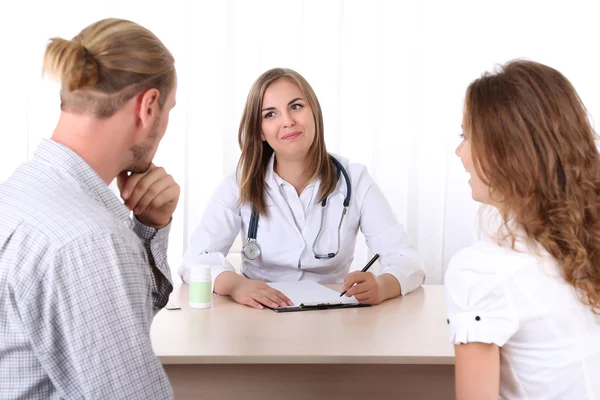 Doctor and young couple patients at office — Stock Photo, Image