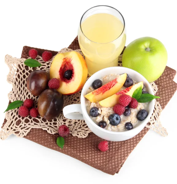 Oatmeal in cup with berries on napkins isolated on white — Stock Photo, Image