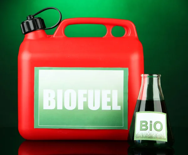 Bio fuels in canister and vial on green background — Stock Photo, Image