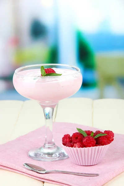 Raspberry milk dessert in cocktail glass, on bright background — Stock Photo, Image