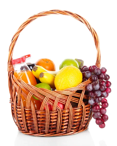 Different fruits in wicker basket with juice isolated on white — Stock Photo, Image